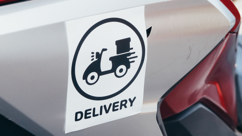 Black and White Delivery Logo Sticker on a Motorcycle 